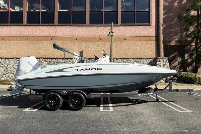 The Image of 2026 Tahoe 2150 CC boat on trailer, parked outdoors, side view. - 0