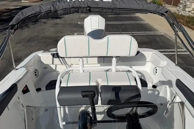 Slide: The Image of 2026 Tahoe 2150 CC boat interior with white seating and steering wheel. - 12