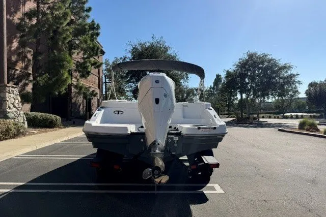 Slide: The Image of 2026 Tahoe 2150 CC boat parked outdoors, rear view with outboard motor. - 4