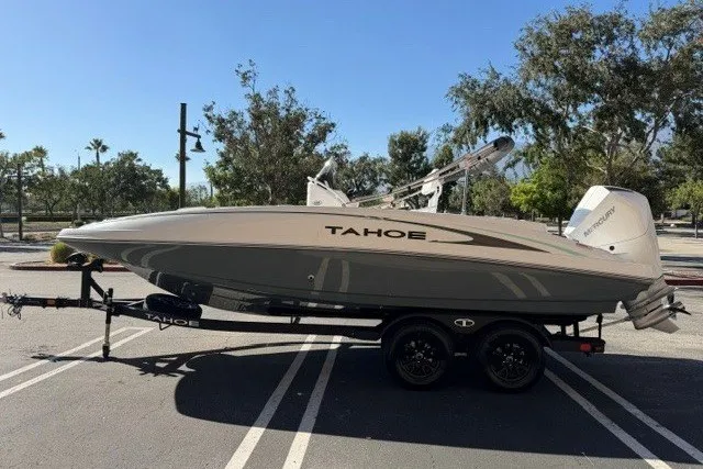 Slide: The Image of 2026 Tahoe 2150 CC boat on trailer in parking lot, side view. - 1