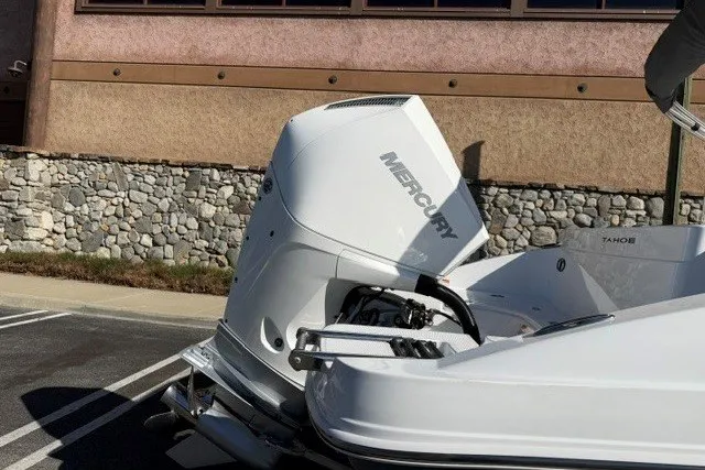 Slide: The Image of 2026 Tahoe 2150 CC boat with Mercury outboard motor in a parking lot. - 6