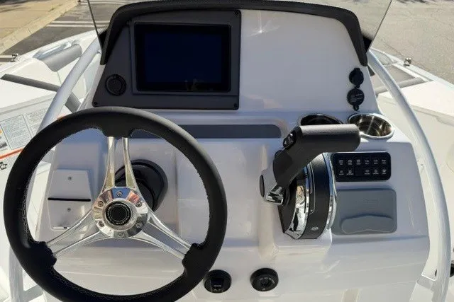 Slide: The Image of Steering console of 2026 Tahoe 2150 CC boat with modern controls and display. - 13