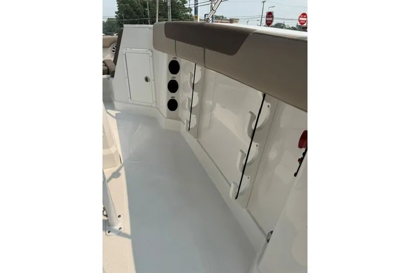 Slide: The Image of 2026 Tahoe 2150 CC boat interior with storage compartments and rod holders. - 16