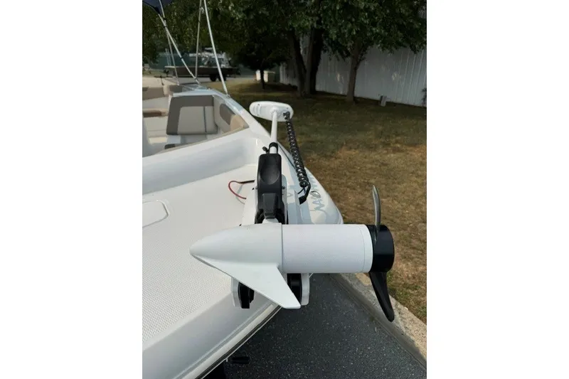 Slide: The Image of 2026 Tahoe 2150 CC boat with trolling motor on deck. - 22