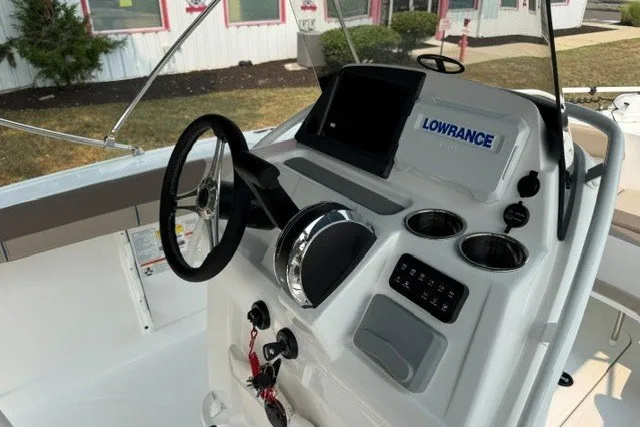 Slide: The Image of 2026 Tahoe 2150 CC boat console with steering wheel and Lowrance navigation system. - 13