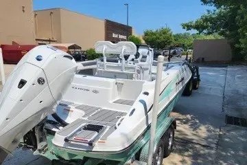 Slide: The Image of 2026 Tahoe 2150 CC boat on trailer, parked outdoors near building. - 116
