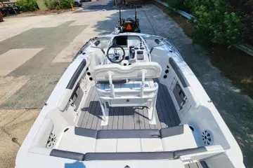 Slide: The Image of 2026 Tahoe 2150 CC boat interior with modern seating and steering console. - 118