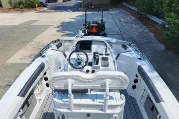 Slide: The Image of 2026 Tahoe 2150 CC boat interior with steering wheel and control panel. - 115