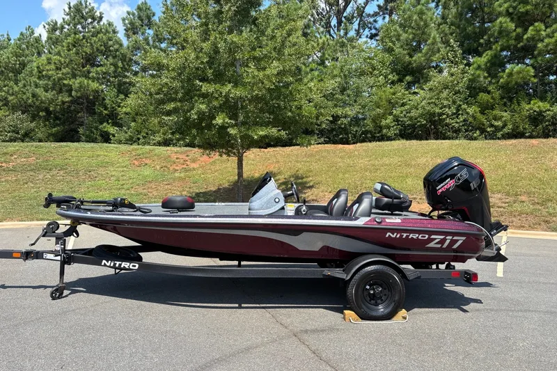 The Image of 2027 Nitro Z17 boat on trailer, parked outdoors with trees in background. - 0