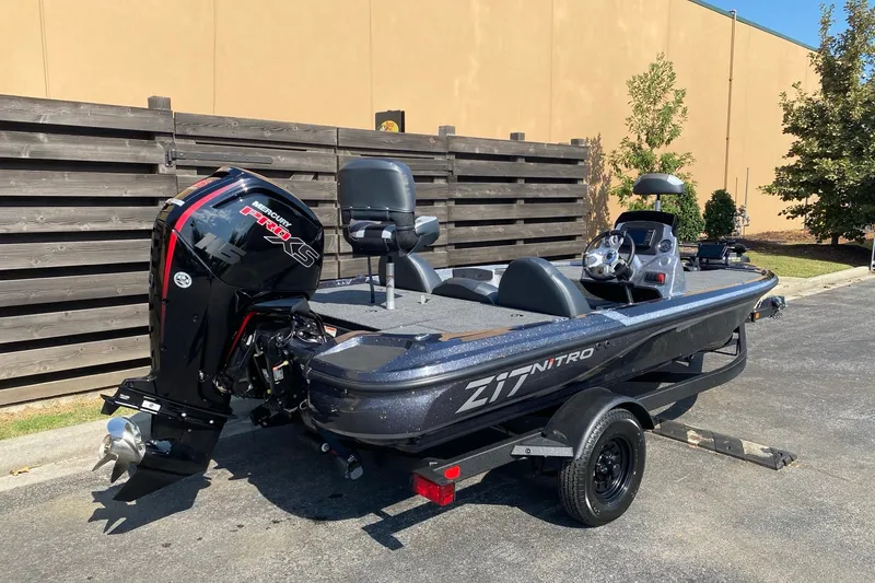 Slide: The Image of 2027 Nitro Z17 boat with Mercury Pro XS engine on trailer, parked outdoors. - 1