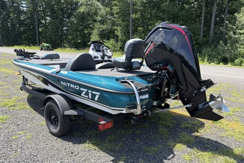 Slide: The Image of 2027 Nitro Z17 boat with powerful outboard motor on a trailer, parked outdoors. - 7
