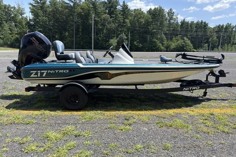 Slide: The Image of 2027 Nitro Z17 boat on trailer in outdoor setting, surrounded by trees. - 3