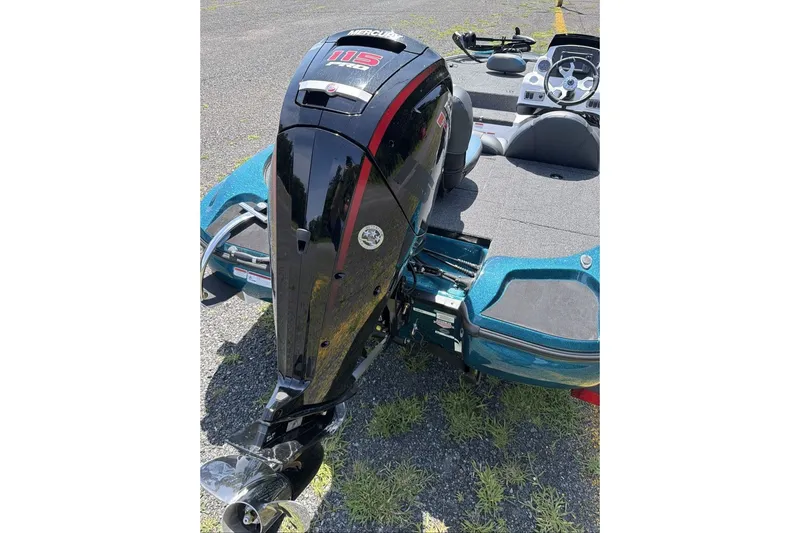 Slide: The Image of 2027 Nitro Z17 boat with Mercury 115 outboard motor, parked on asphalt. - 5