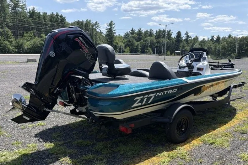 Slide: The Image of Nitro Z17 2027 boat on trailer, parked outdoors with trees in background. - 4