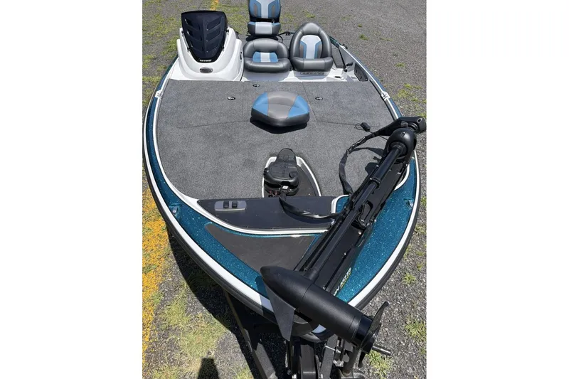 Slide: The Image of 2027 Nitro Z17 fishing boat with trolling motor and seating on a gravel surface. - 9