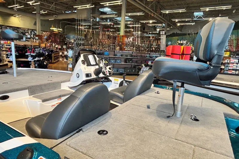Slide: The Image of 2027 Nitro Z17 boat interior with seating and steering wheel in a showroom. - 1