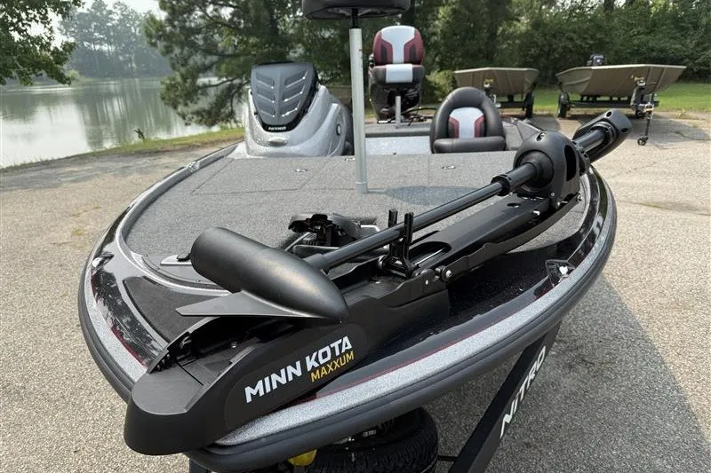 Slide: The Image of 2027 Nitro Z17 boat with Minn Kota Maxxum trolling motor by a lake. - 2