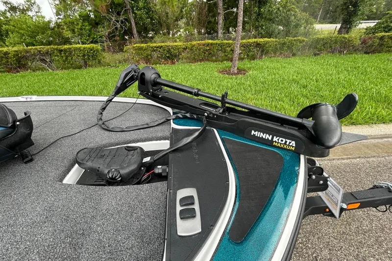 Slide: The Image of Minn Kota Maxxum trolling motor on Nitro Z17 boat, 2027 model, parked on grass. - 8