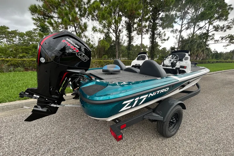 Slide: The Image of 2027 Nitro Z17 boat with Mercury Pro XS engine on a trailer, parked outdoors. - 1