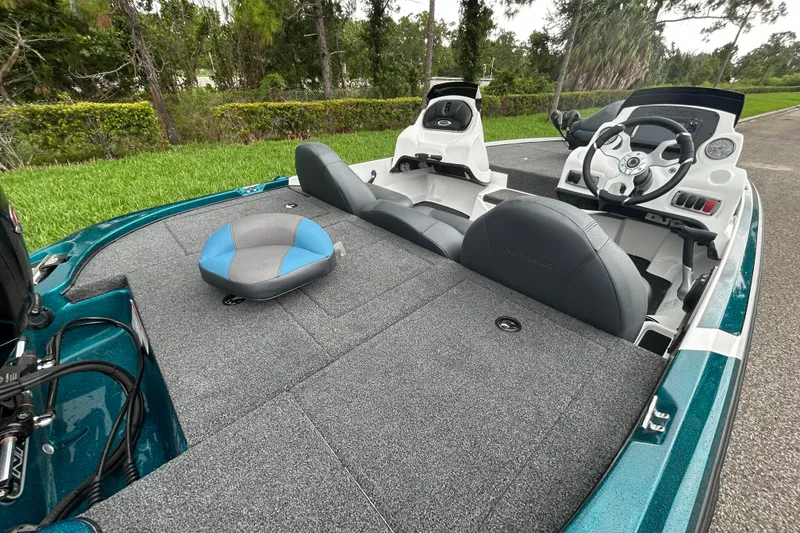Slide: The Image of 2027 Nitro Z17 boat interior with seating and steering wheel, parked on a road. - 13