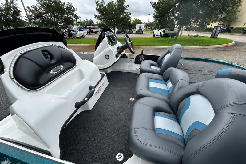 Slide: The Image of 2027 Nitro Z17 boat interior with gray and blue seating, steering console, and storage compartments. - 14