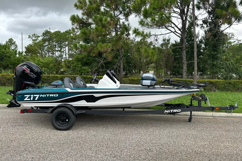 The Image of 2027 Nitro Z17 boat on trailer, parked on road with trees in background. - 0