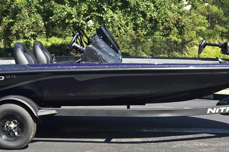 The Image of 2027 Nitro Z17 boat on trailer, parked outdoors with lush greenery background. - 0