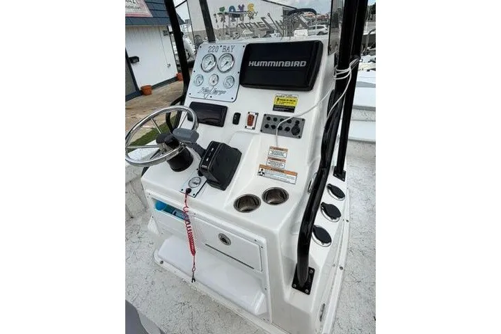 Slide: The Image of Console of 2018 Key Largo 220 Bay boat with steering wheel and gauges. - 20