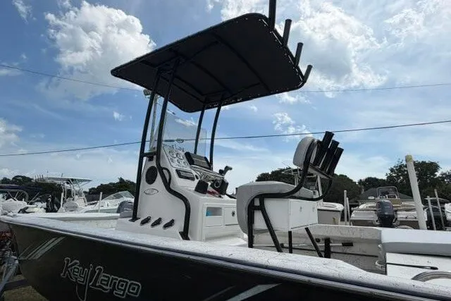 Slide: The Image of 2018 Key Largo 220 Bay boat with T-top under a partly cloudy sky. - 4