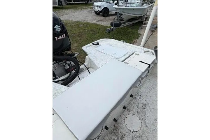 Slide: The Image of 2018 Key Largo 220 Bay boat with Suzuki 140 outboard motor, parked on grass. - 22