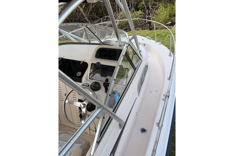 Slide: The Image of 2008 Grady-White Seafarer 226 boat cockpit with steering wheel and dashboard view. - 2