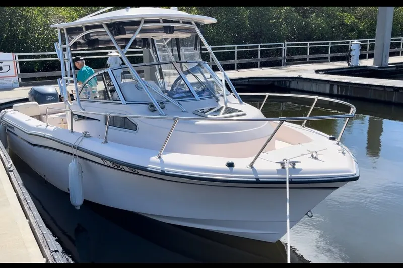 Slide: The Image of 2008 Grady-White Seafarer 226 boat docked in a marina. - 1