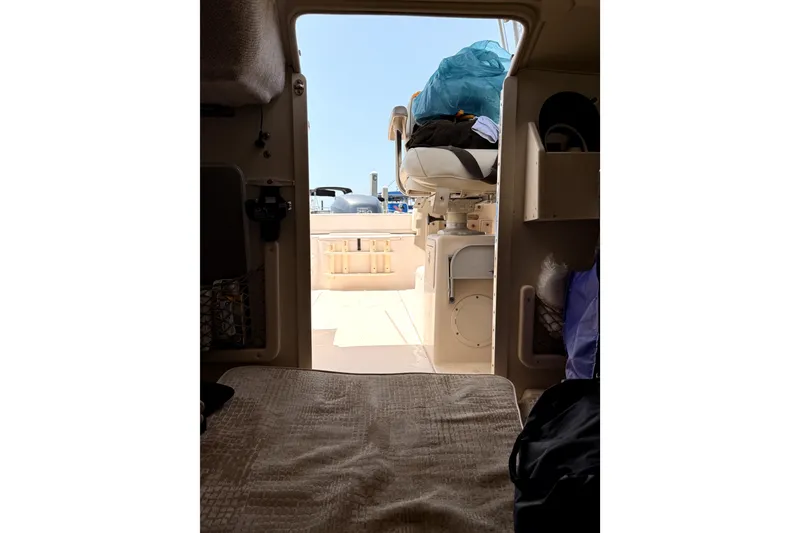 Slide: The Image of Interior view of 2008 Grady-White Seafarer 226 boat cabin, showing seating and storage. - 8