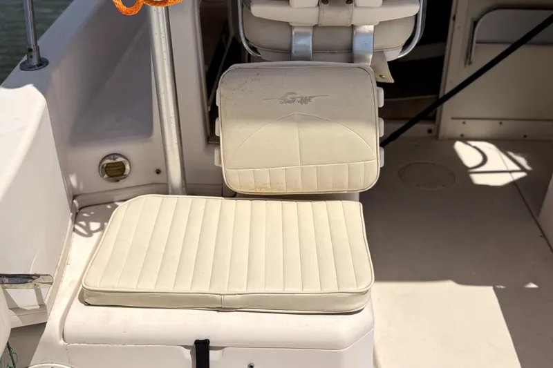 Slide: The Image of Grady-White Seafarer 226 boat interior seating, 2008 model, featuring white cushioned seats. - 6