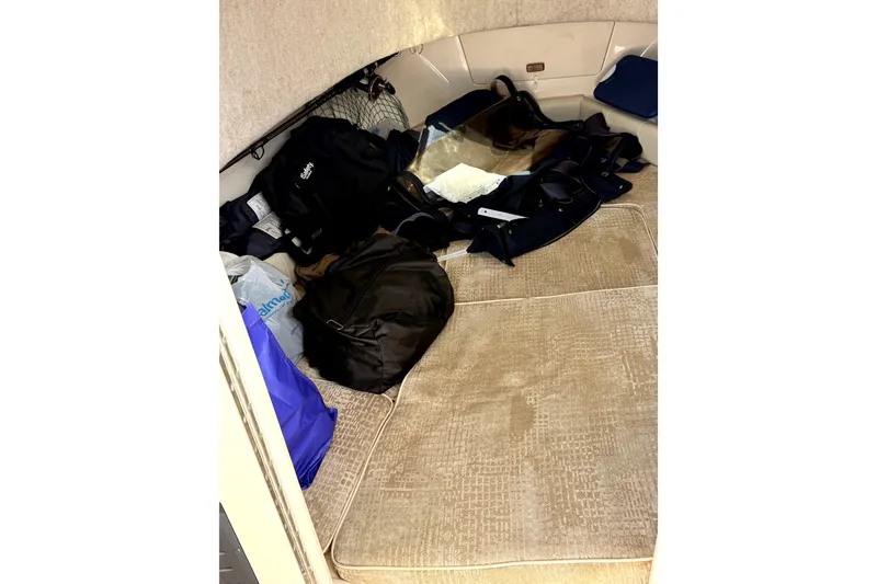 Slide: The Image of Interior cabin of 2008 Grady-White Seafarer 226 with bags and gear. - 13