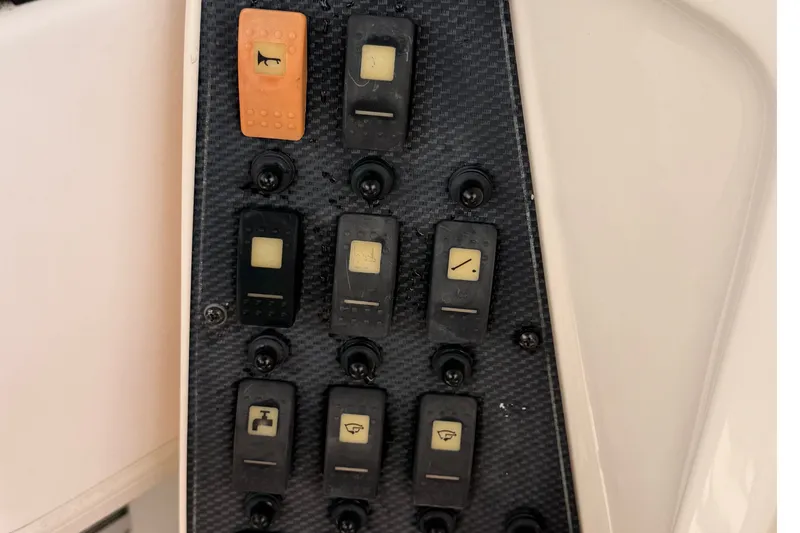Slide: The Image of Control panel of a 2008 Grady-White Seafarer 226 boat with various switches. - 40