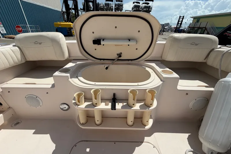 Slide: The Image of 2008 Grady-White Seafarer 226 boat interior with storage compartment and rod holders. - 57