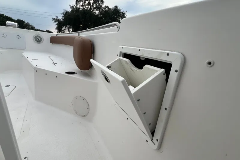 Slide: The Image of 2015 Tidewater 250 CC Adventure boat interior with storage compartment and seating. - 33