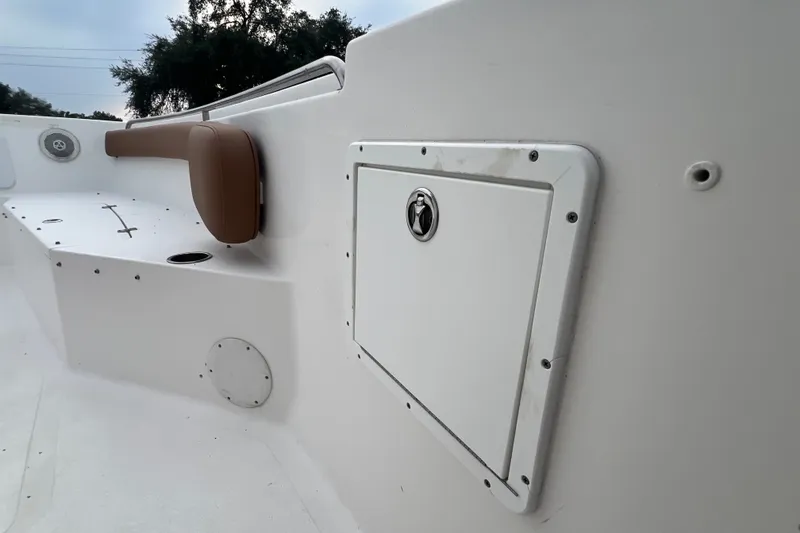 Slide: The Image of 2015 Tidewater 250 CC Adventure boat interior with storage compartment and seating. - 34