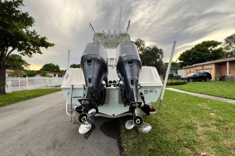 Slide: The Image of 2015 Tidewater 250 CC Adventure boat with dual outboard motors on a residential street. - 19