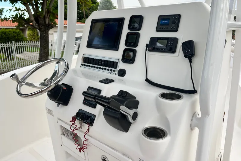 Slide: The Image of Control panel of a 2015 Tidewater 250 CC Adventure boat with steering wheel and navigation instruments. - 39
