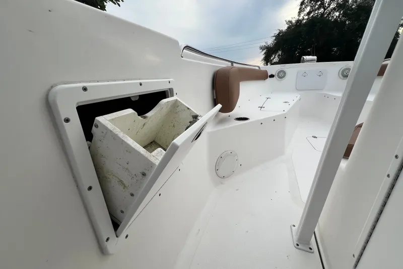 Slide: The Image of 2015 Tidewater 250 CC Adventure boat interior with open storage compartment. - 21