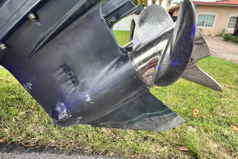 Slide: The Image of Close-up of a 2015 Tidewater 250 CC Adventure boat propeller on grass. - 15