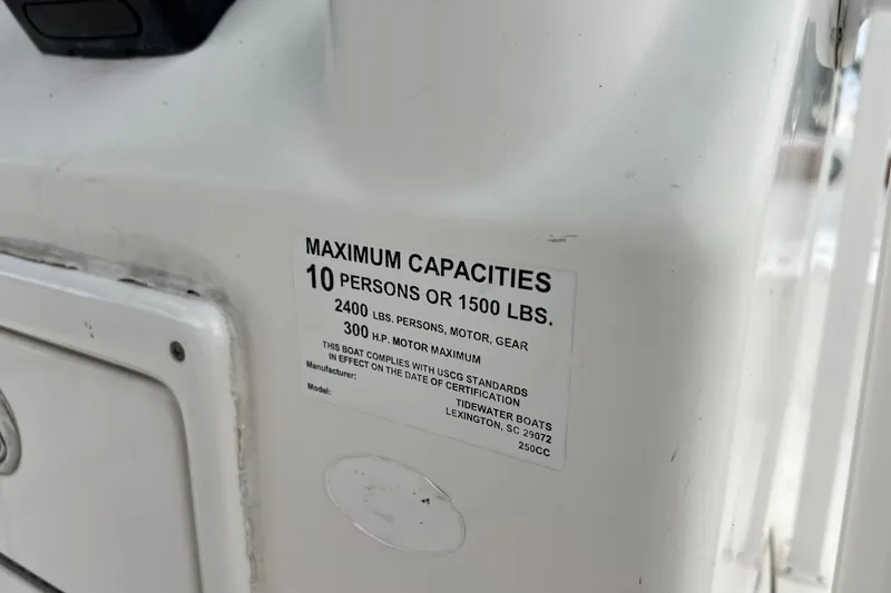 Slide: The Image of Capacity label on 2015 Tidewater 250 CC Adventure boat, detailing weight and passenger limits. - 38