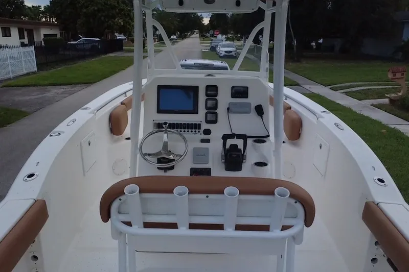 Slide: The Image of 2015 Tidewater 250 CC Adventure boat interior with steering console and seating. - 68