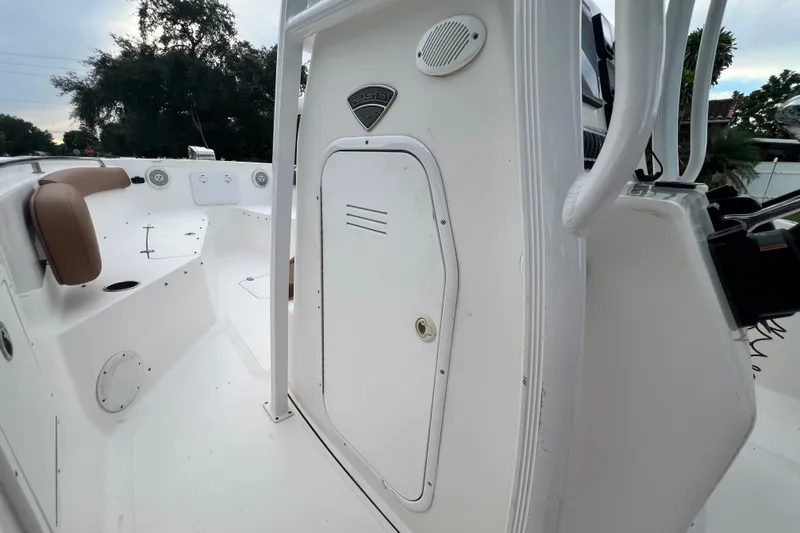 Slide: The Image of 2015 Tidewater 250 CC Adventure boat interior with seating and storage. - 51