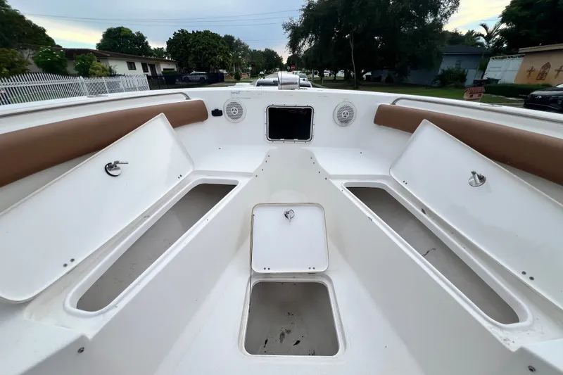 Slide: The Image of 2015 Tidewater 250 CC Adventure boat interior with storage compartments and seating. - 59
