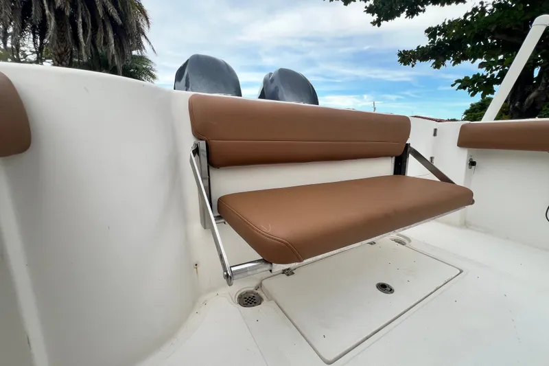 Slide: The Image of Brown cushioned seat on 2015 Tidewater 250 CC Adventure boat, with dual engines visible. - 23