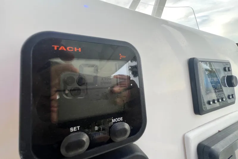 Slide: The Image of Close-up of 2015 Tidewater 250 CC Adventure boat dashboard with tachometer and radio display. - 47