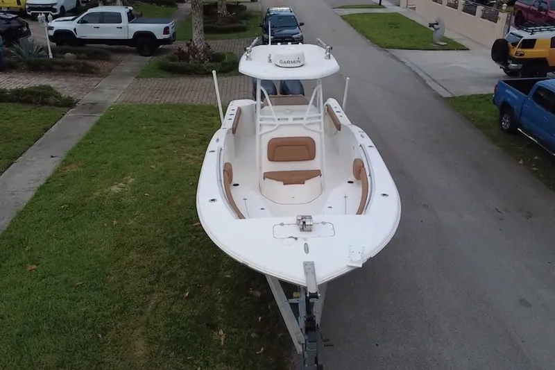 Slide: The Image of 2015 Tidewater 250 CC Adventure boat on trailer, parked in residential area. - 69